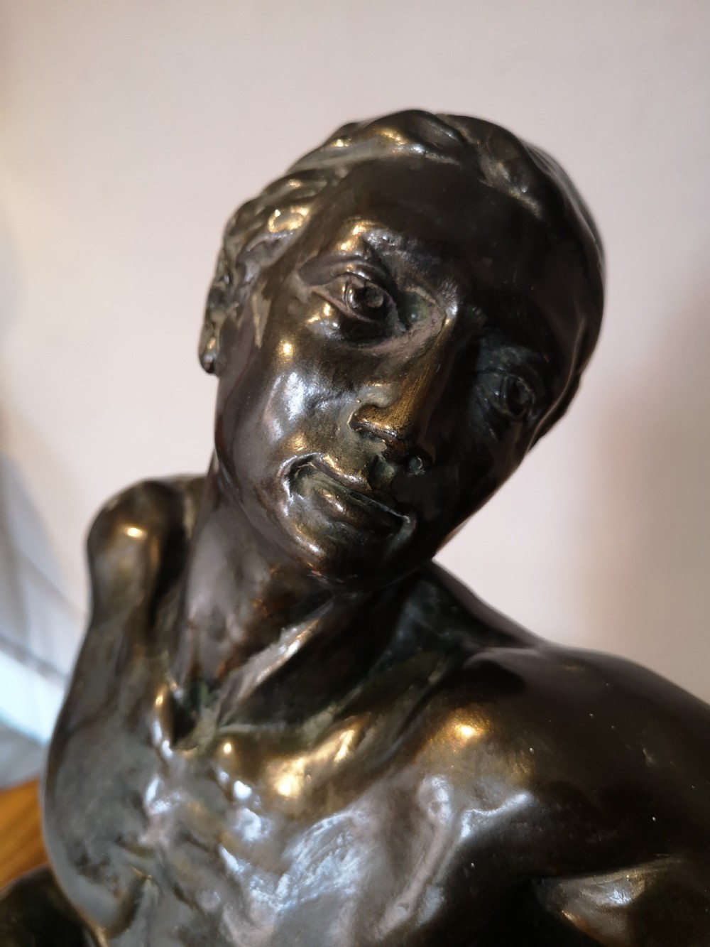 Patinated bronze sculpture of a reclining male nude View II