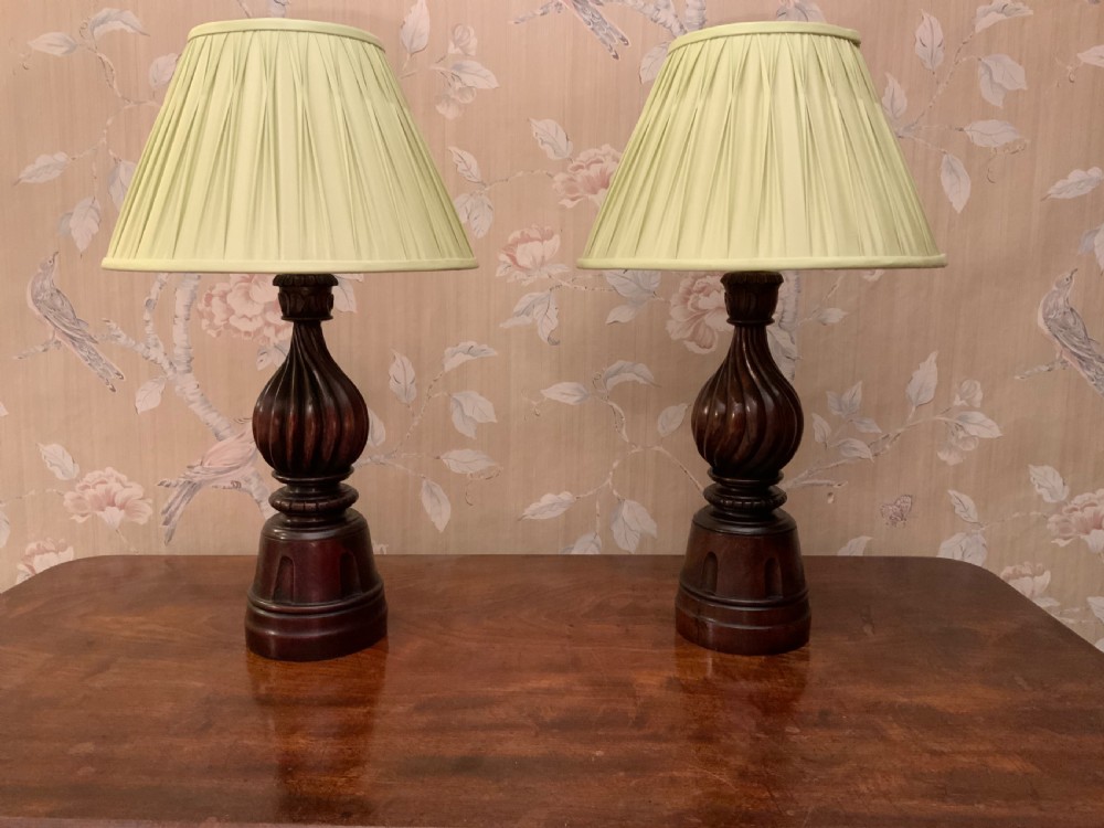 A pair of mahogany based table lamps