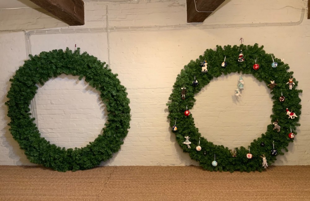 A very large pair of window dressing wreaths