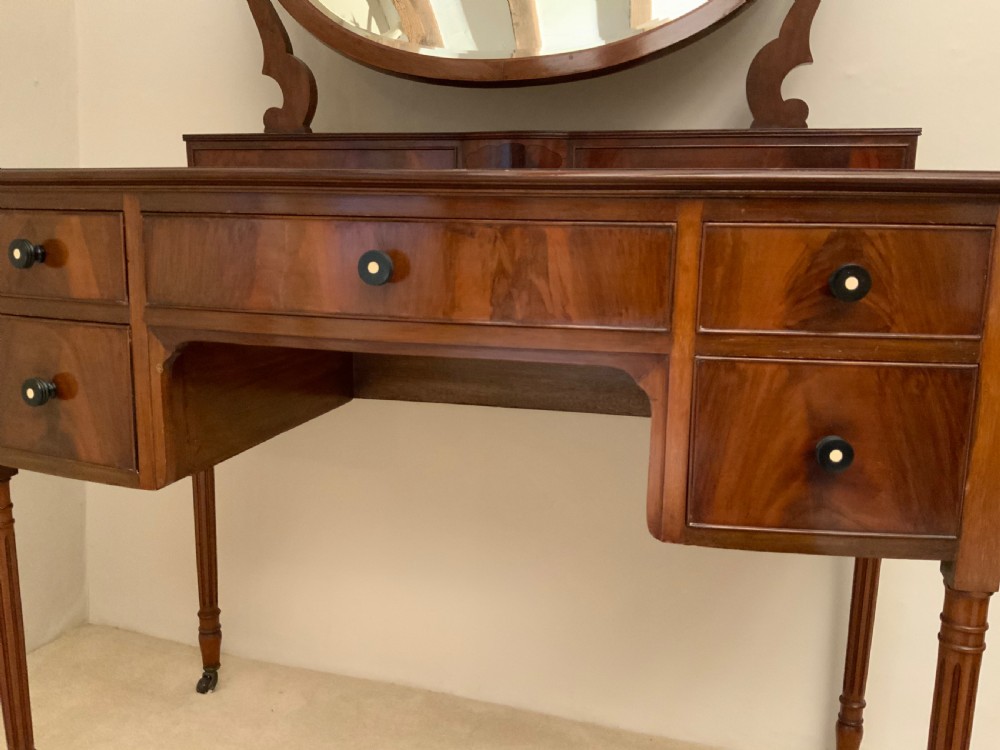 A bow front mahogany kneehole dressing table View IV