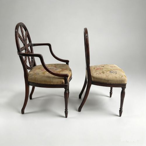 fig 1. A set of ten mahogany wheelback dining chairs with carved circular backs and floral tapestry upholstered seats.