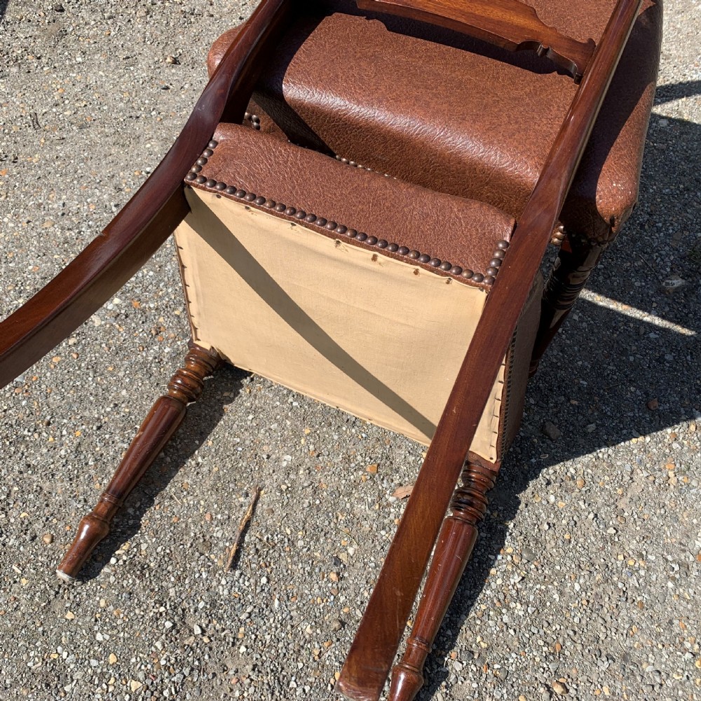 A set of four Regency mahogany dining chairs with carved bar backs, dark brown upholstered seats, and turned front legs. View VIII