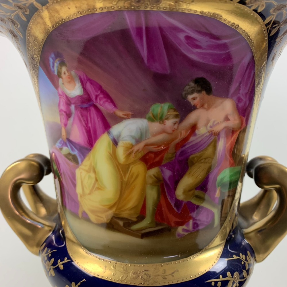 A pair of cobalt blue and gold Vienna porcelain urns with hand-painted classical scenes on square plinths. View III