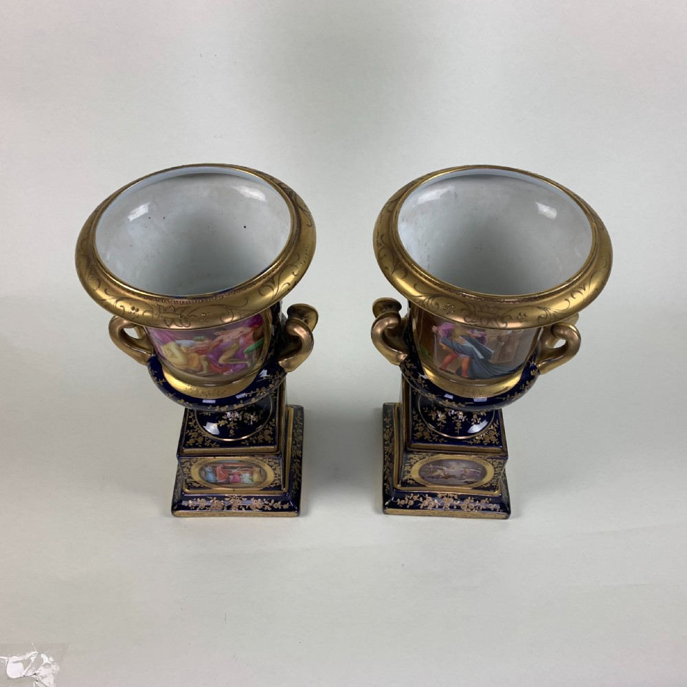 A pair of cobalt blue and gold Vienna porcelain urns with hand-painted classical scenes on square plinths. View VIII