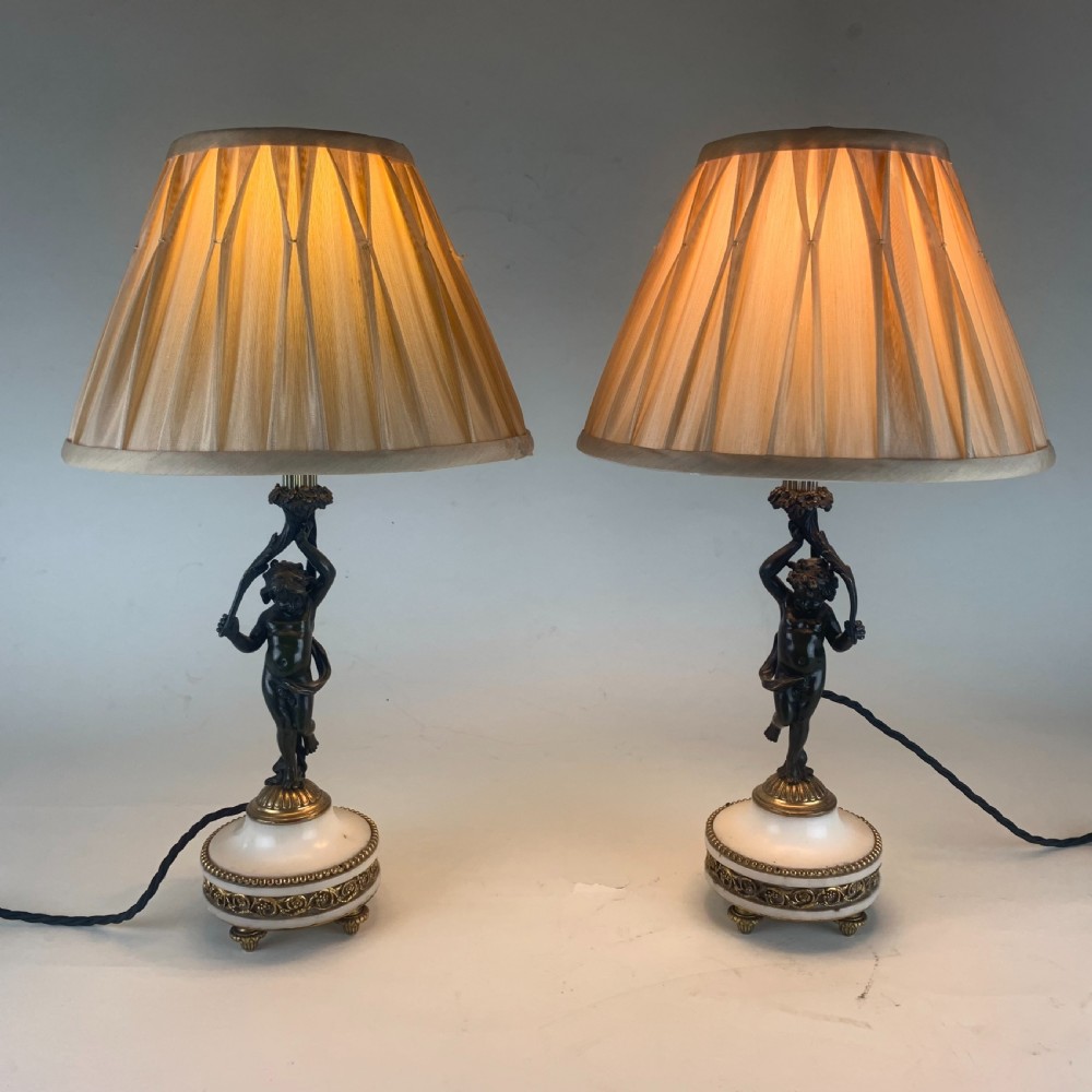 Pair of bronze putti table lamps