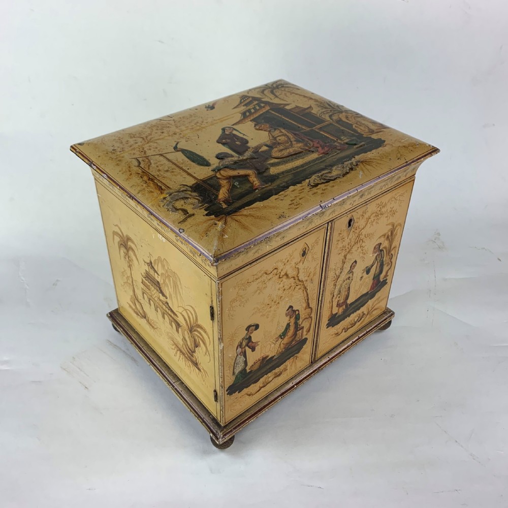 An early nineteenth-century yellow japanned workbox with gilt chinoiserie decoration, a hinged lid revealing red silk compartments, and front doors opening to inner drawers. View II