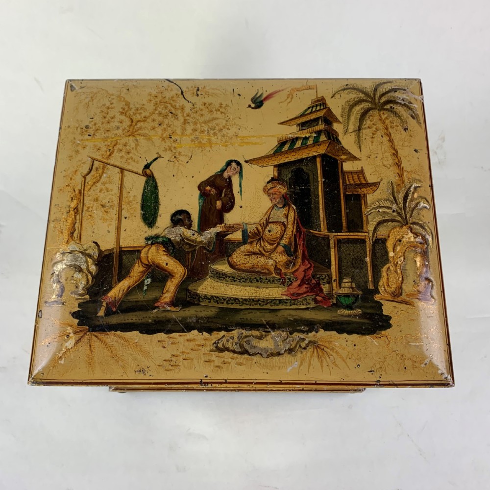 An early nineteenth-century yellow japanned workbox with gilt chinoiserie decoration, a hinged lid revealing red silk compartments, and front doors opening to inner drawers. View III