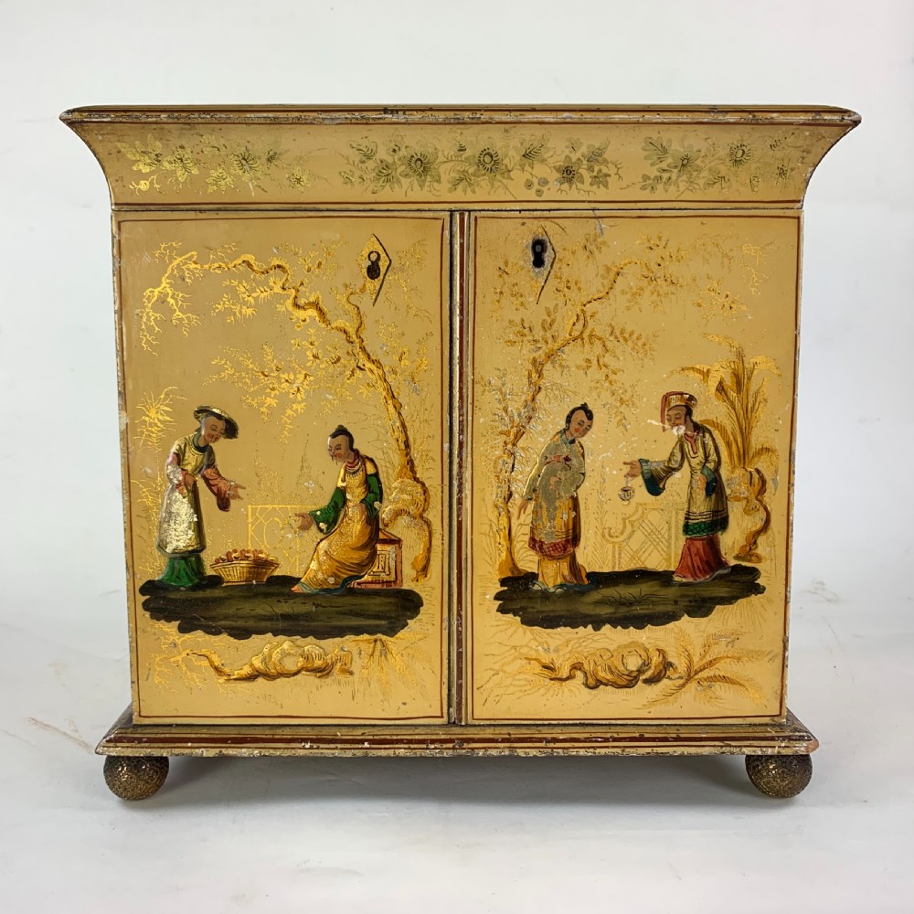 An early nineteenth-century yellow japanned workbox with gilt chinoiserie decoration, a hinged lid revealing red silk compartments, and front doors opening to inner drawers. View IV