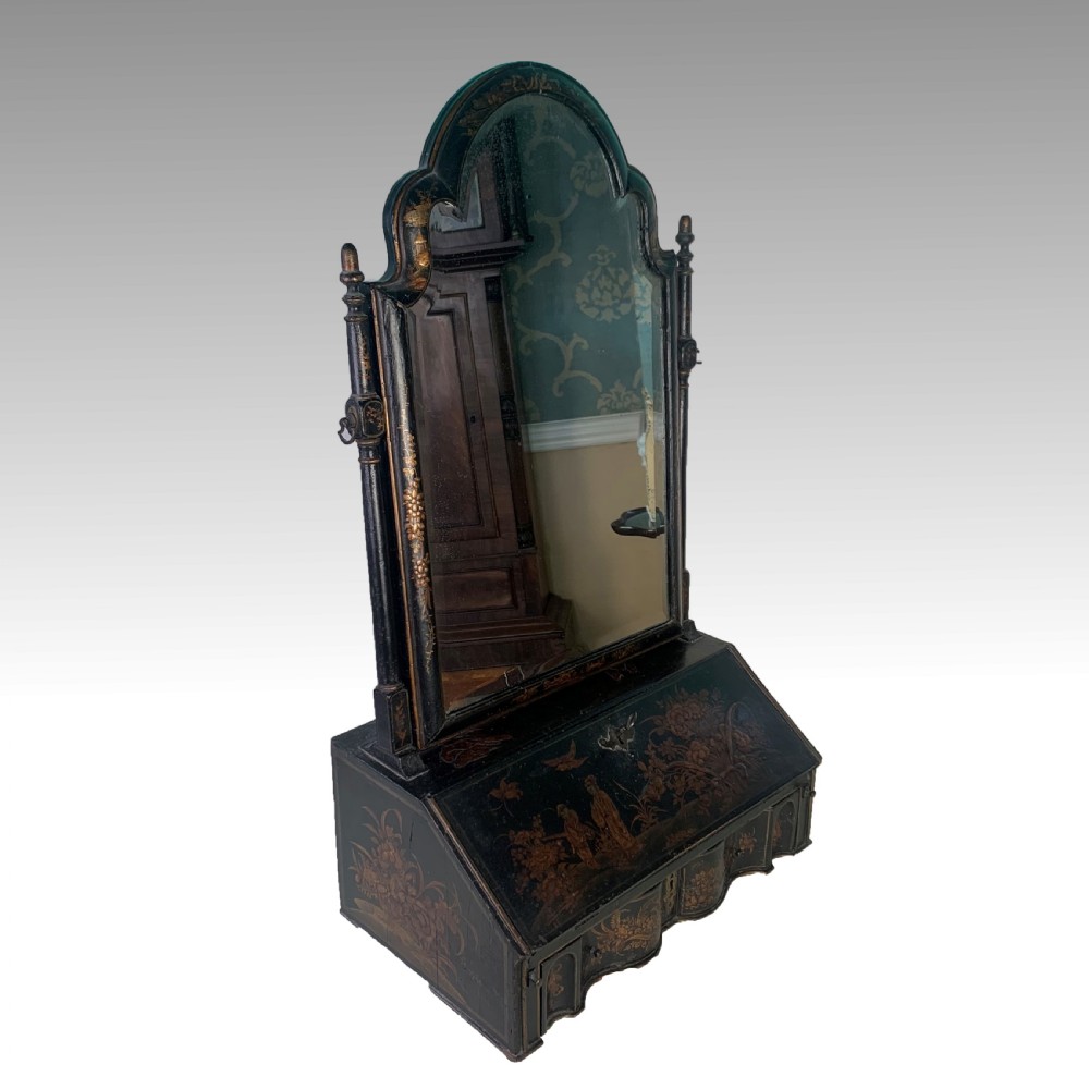 A black lacquered toilet mirror featuring an arched frame and gilded Chinoiserie artwork mounted on a miniature slant-front bureau base. View III