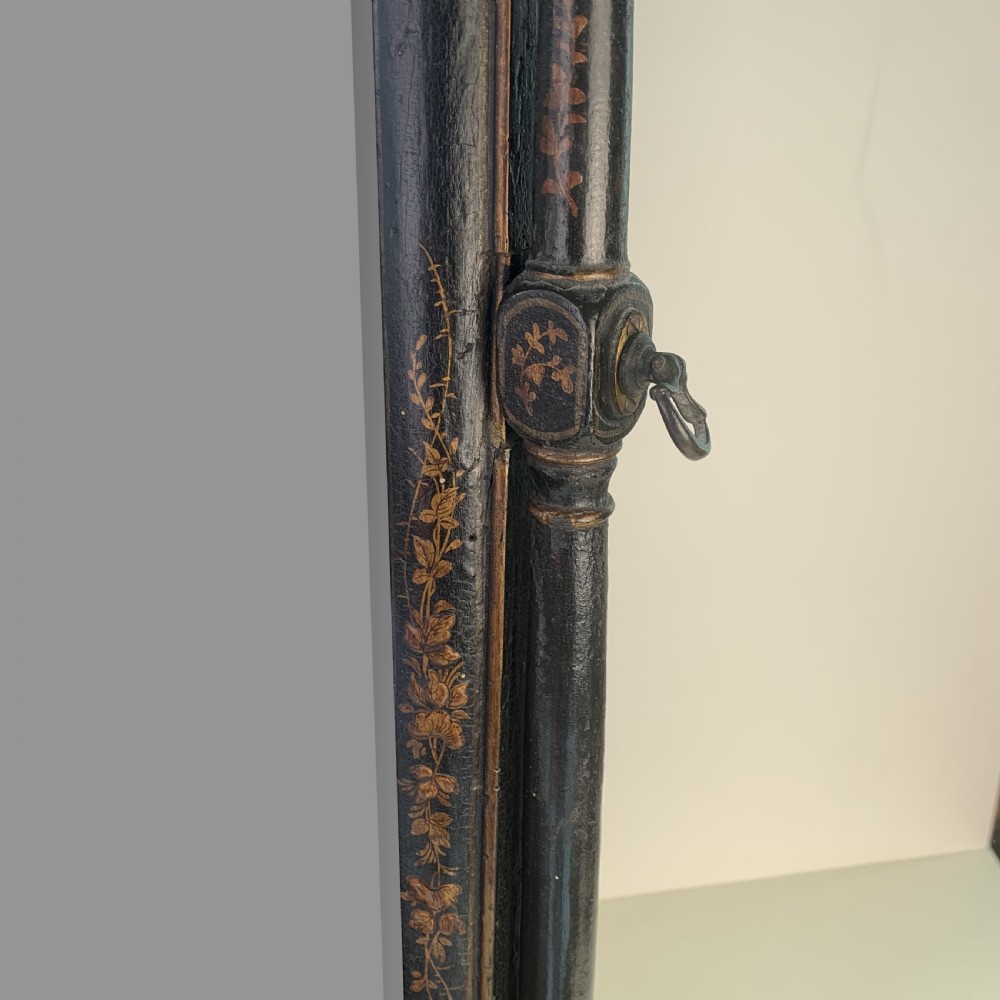 A black lacquered toilet mirror featuring an arched frame and gilded Chinoiserie artwork mounted on a miniature slant-front bureau base. View XI