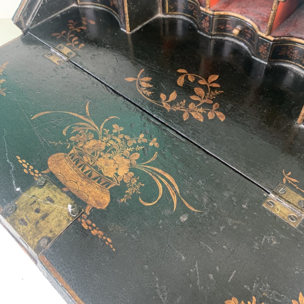 A black lacquered toilet mirror featuring an arched frame and gilded Chinoiserie artwork mounted on a miniature slant-front bureau base. View XIII