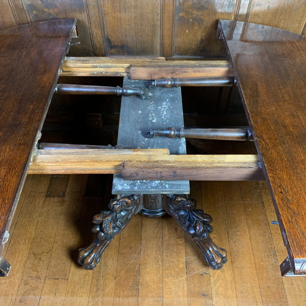 Extending Oak Dining Table with carved base View IX