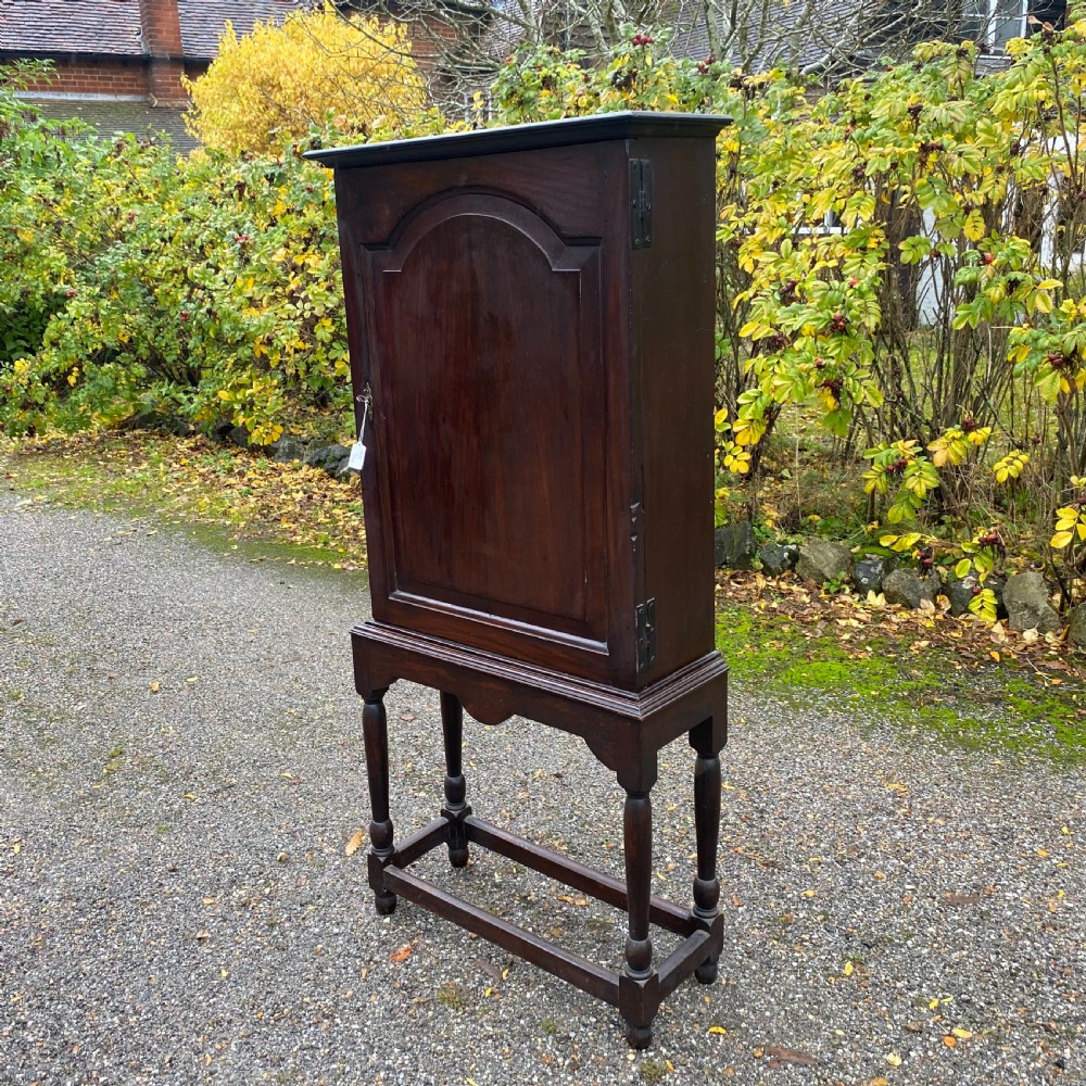 Early 19th century oak cupboard on stand
