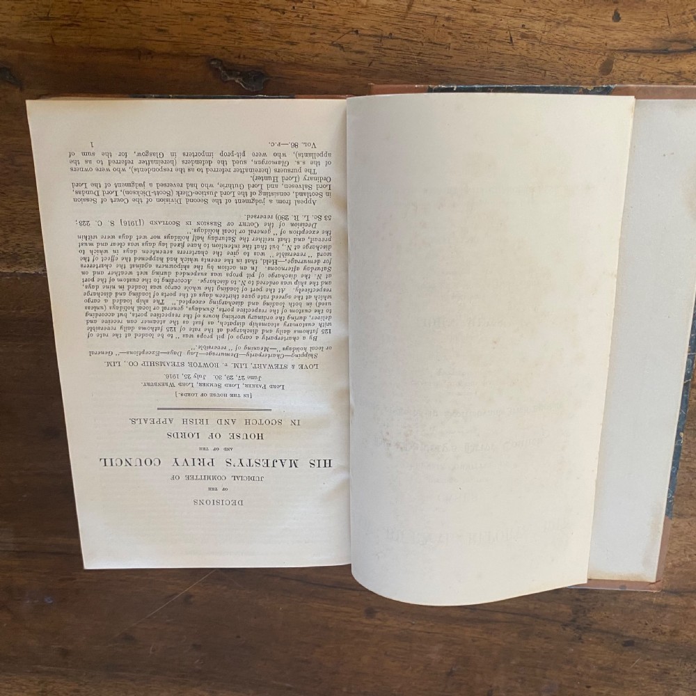 A continuous shelf run of uniform antique leather-bound Law Journal Reports featuring tan calfskin spines, contrasting red and dark labels, and gilt lettering. View V