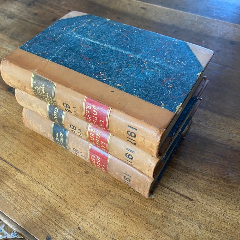 A continuous shelf run of uniform antique leather-bound Law Journal Reports featuring tan calfskin spines, contrasting red and dark labels, and gilt lettering. View VI