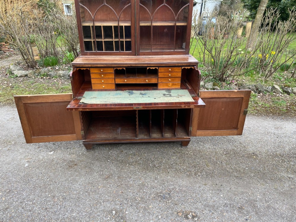 George IV mahogany secretaire bookcase with gothic arch astragal glazed upper doors, a deep secretaire drawer, and a lower two-door cupboard. View IX