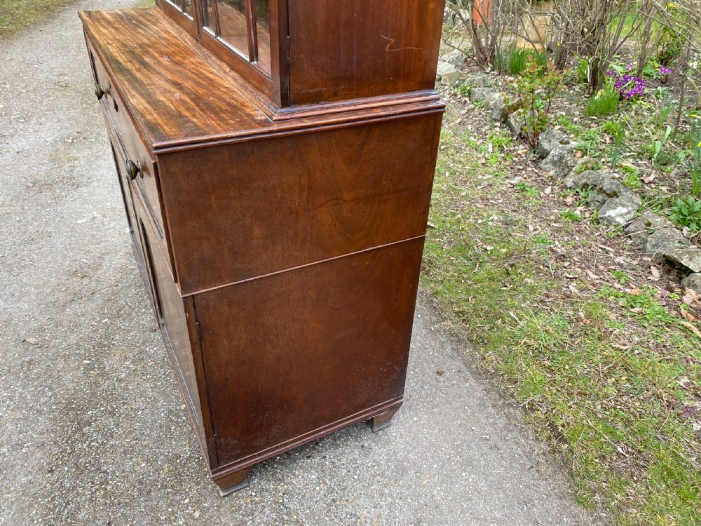 George IV mahogany secretaire bookcase with gothic arch astragal glazed upper doors, a deep secretaire drawer, and a lower two-door cupboard. View X