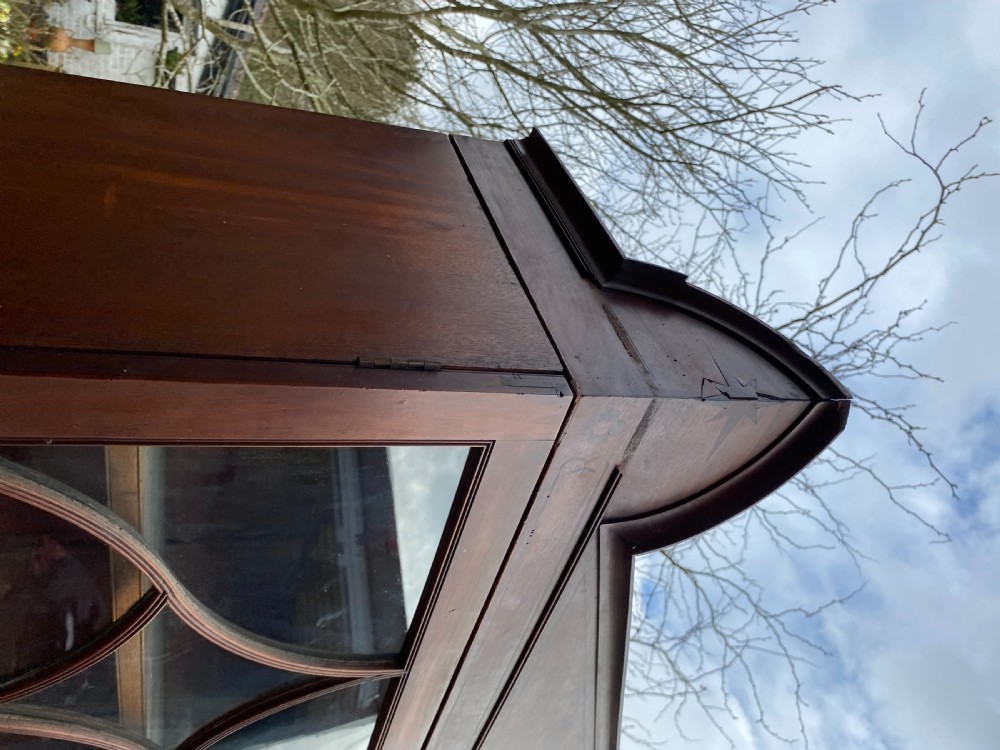 George IV mahogany secretaire bookcase with gothic arch astragal glazed upper doors, a deep secretaire drawer, and a lower two-door cupboard. View XVII