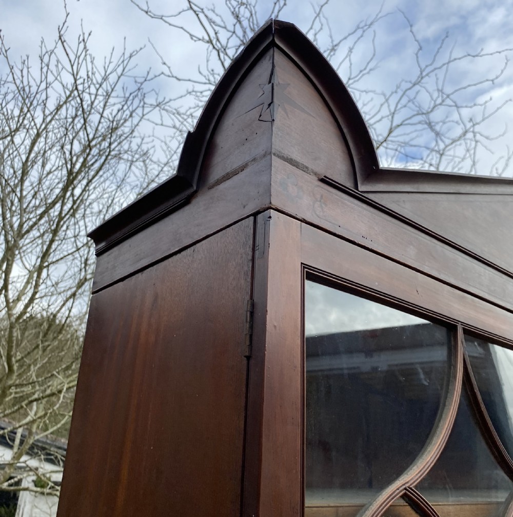 George IV mahogany secretaire bookcase with gothic arch astragal glazed upper doors, a deep secretaire drawer, and a lower two-door cupboard. View XX