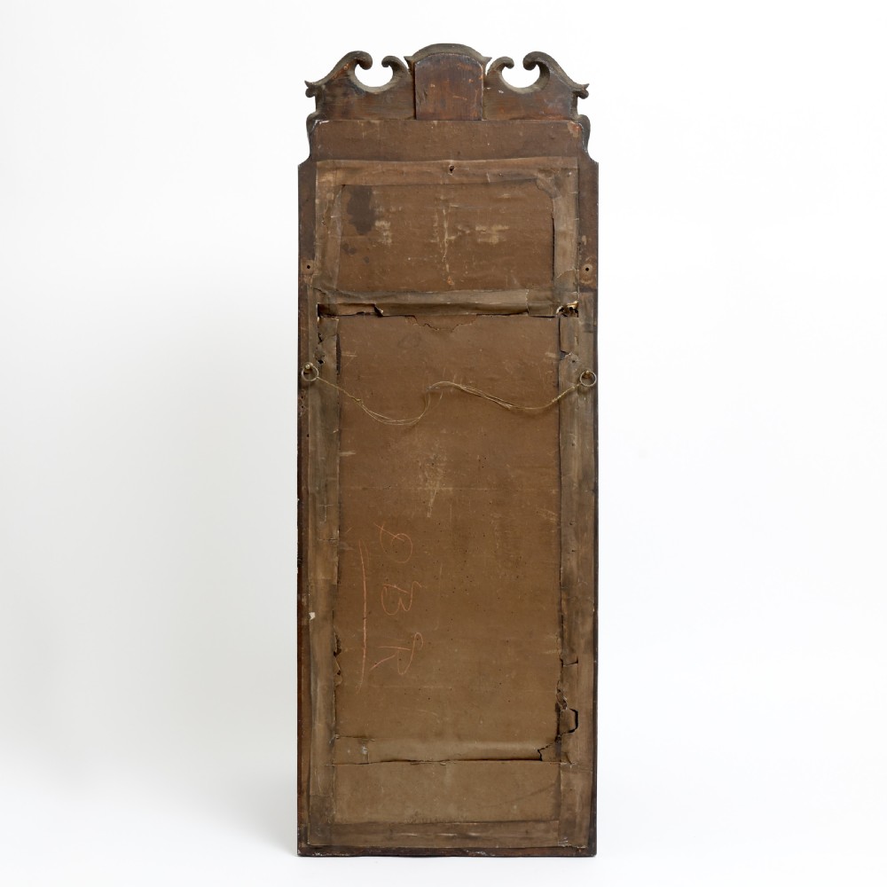 A tall Queen Anne walnut pier mirror featuring an arched frame with a carved gilded shell crest and two-section foxed mirror glass. View III