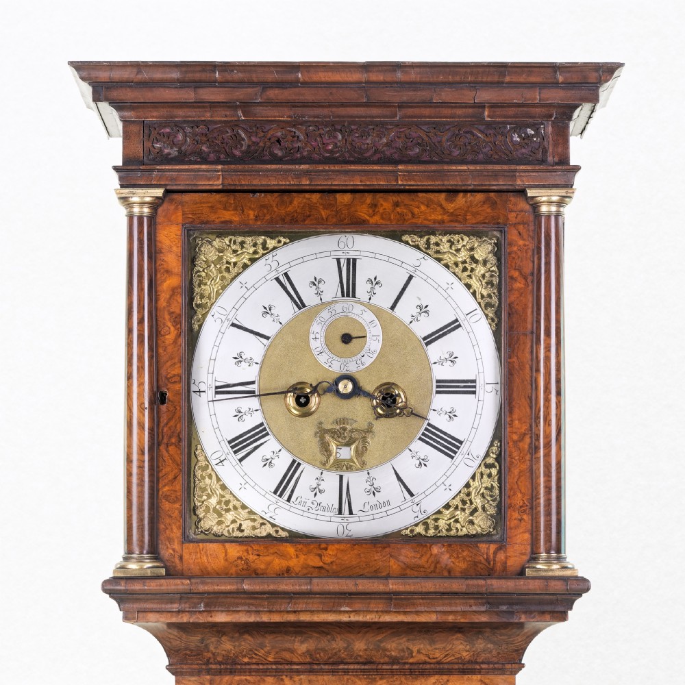 An eighteenth-century burr walnut longcase clock featuring a square brass dial, silvered chapter ring, and moulded pedestal base. View III