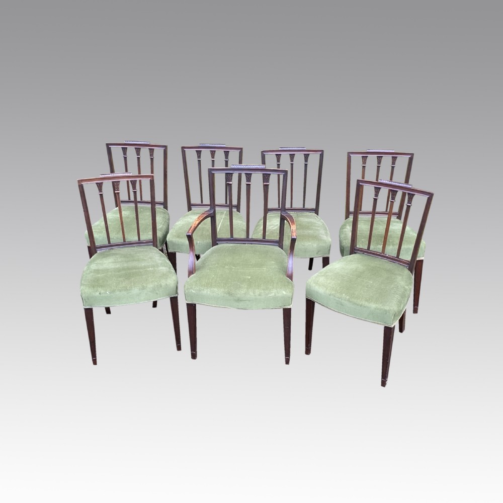 A set of seven mahogany dining chairs, including six side chairs and one carver armchair, with square backs and green velvet seats. View III