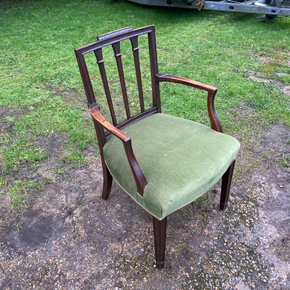 A set of seven mahogany dining chairs, including six side chairs and one carver armchair, with square backs and green velvet seats. View VII