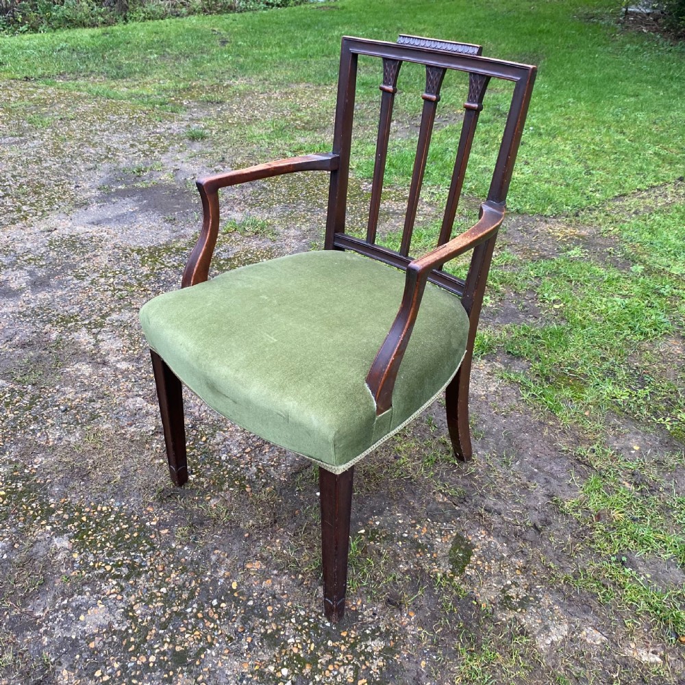A set of seven mahogany dining chairs, including six side chairs and one carver armchair, with square backs and green velvet seats. View VIII