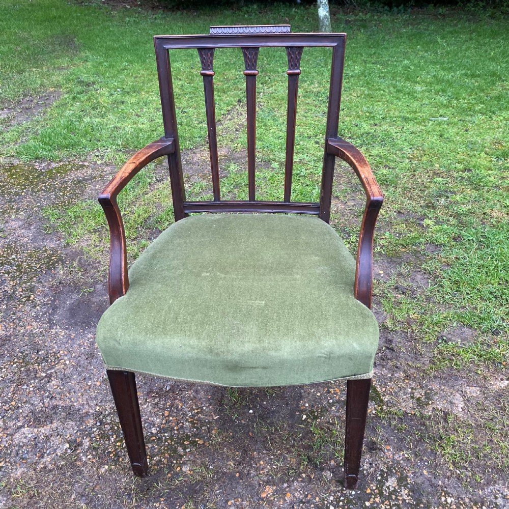 A set of seven mahogany dining chairs, including six side chairs and one carver armchair, with square backs and green velvet seats. View IX