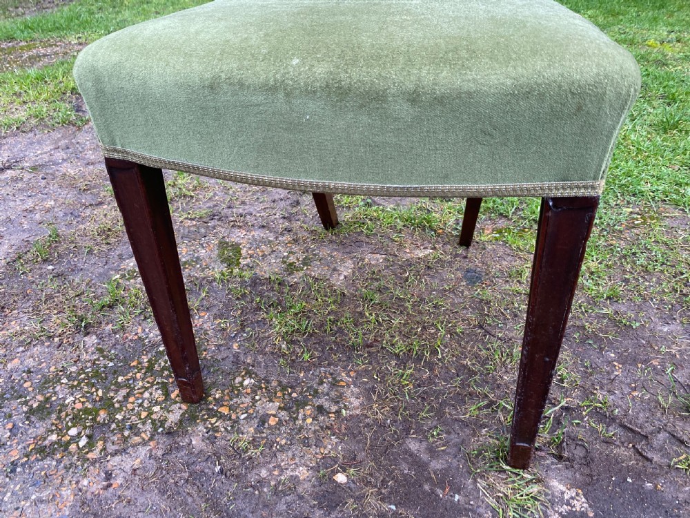 A set of seven mahogany dining chairs, including six side chairs and one carver armchair, with square backs and green velvet seats. View XII