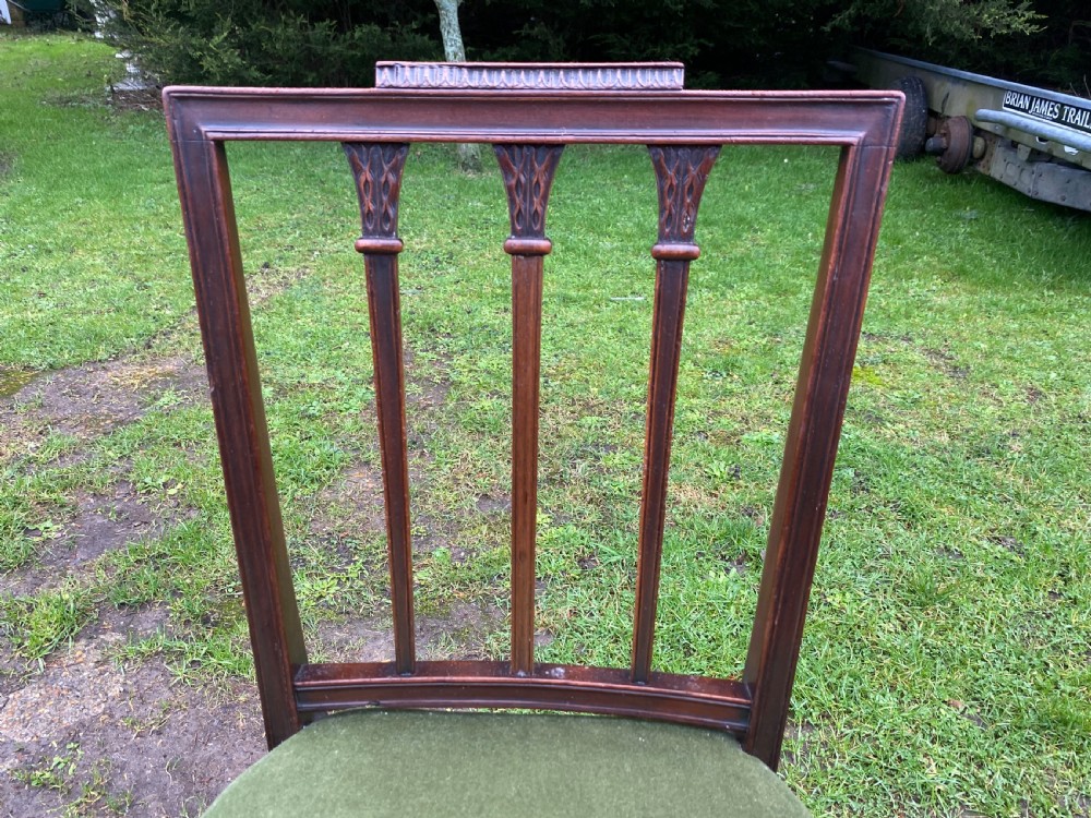 A set of seven mahogany dining chairs, including six side chairs and one carver armchair, with square backs and green velvet seats. View XIII