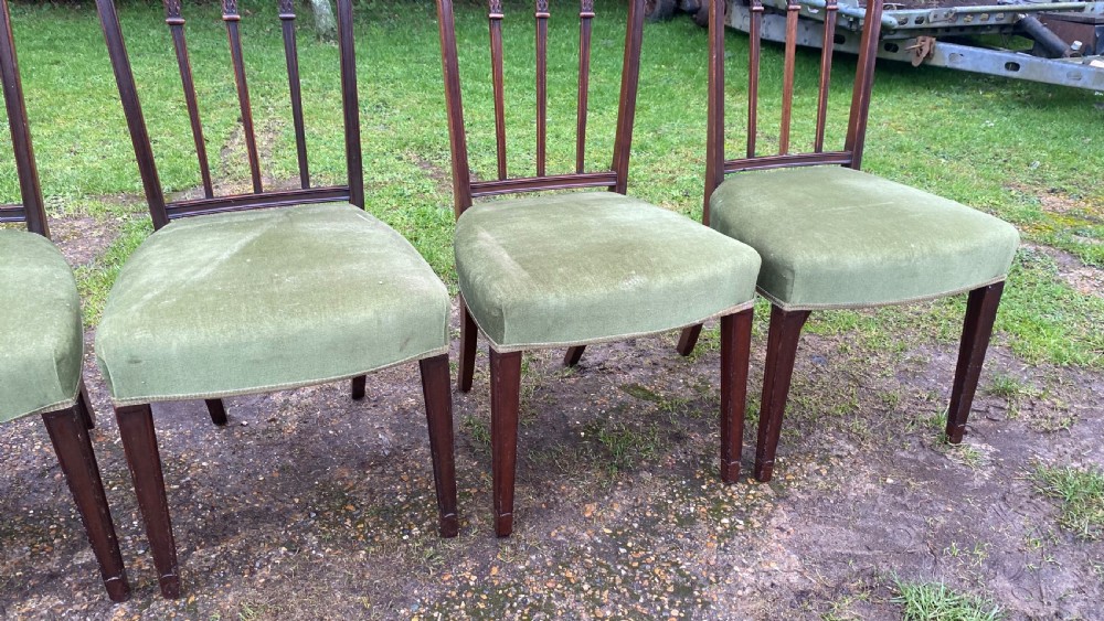 A set of seven mahogany dining chairs, including six side chairs and one carver armchair, with square backs and green velvet seats. View XIV