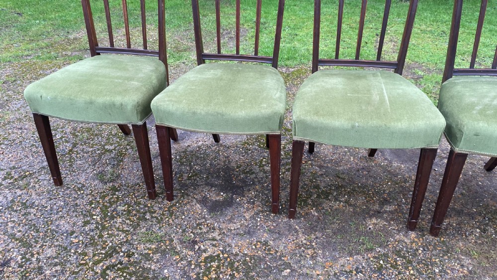 A set of seven mahogany dining chairs, including six side chairs and one carver armchair, with square backs and green velvet seats. View XVI