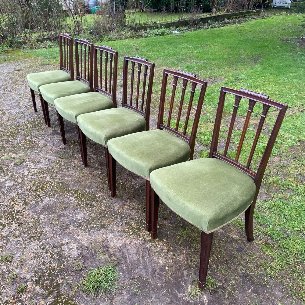 A set of seven mahogany dining chairs, including six side chairs and one carver armchair, with square backs and green velvet seats. View XVII