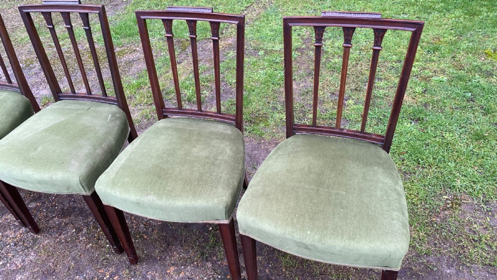 A set of seven mahogany dining chairs, including six side chairs and one carver armchair, with square backs and green velvet seats. View XVIII