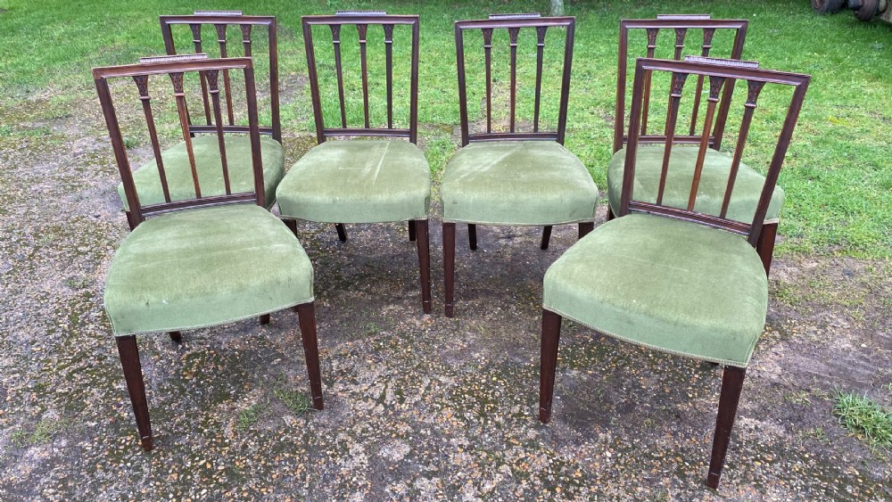 A set of seven mahogany dining chairs, including six side chairs and one carver armchair, with square backs and green velvet seats. View XIX