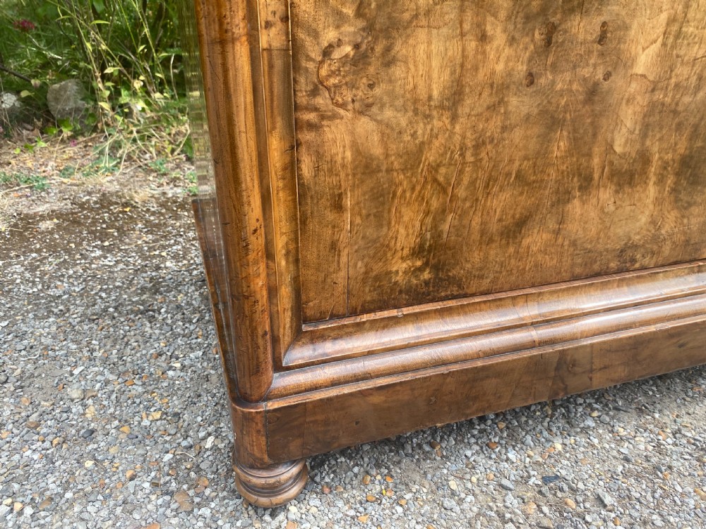 A tall antique burr walnut bonnetiere wardrobe cupboard featuring double panelled doors and a moulded top cornice. View X