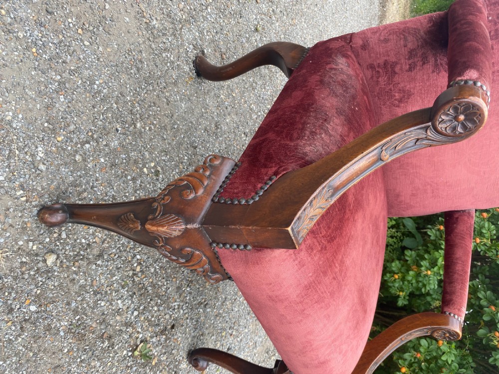 A 19th-century George III style Gainsborough armchair featuring rose pink velvet upholstery, open carved mahogany arms, and carved cabriole legs. View XI