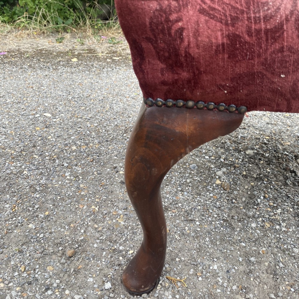 A 19th-century George III style Gainsborough armchair featuring rose pink velvet upholstery, open carved mahogany arms, and carved cabriole legs. View XVII