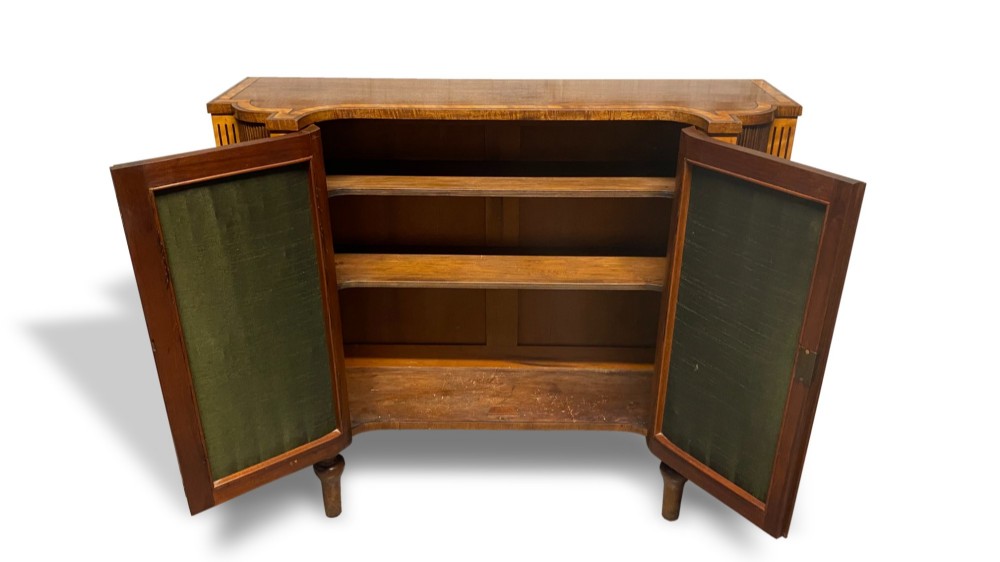 A Georgian satinwood side cabinet featuring two wire-mesh panelled doors lined with green fabric, flanked by fluted pilasters on turned legs. View VI