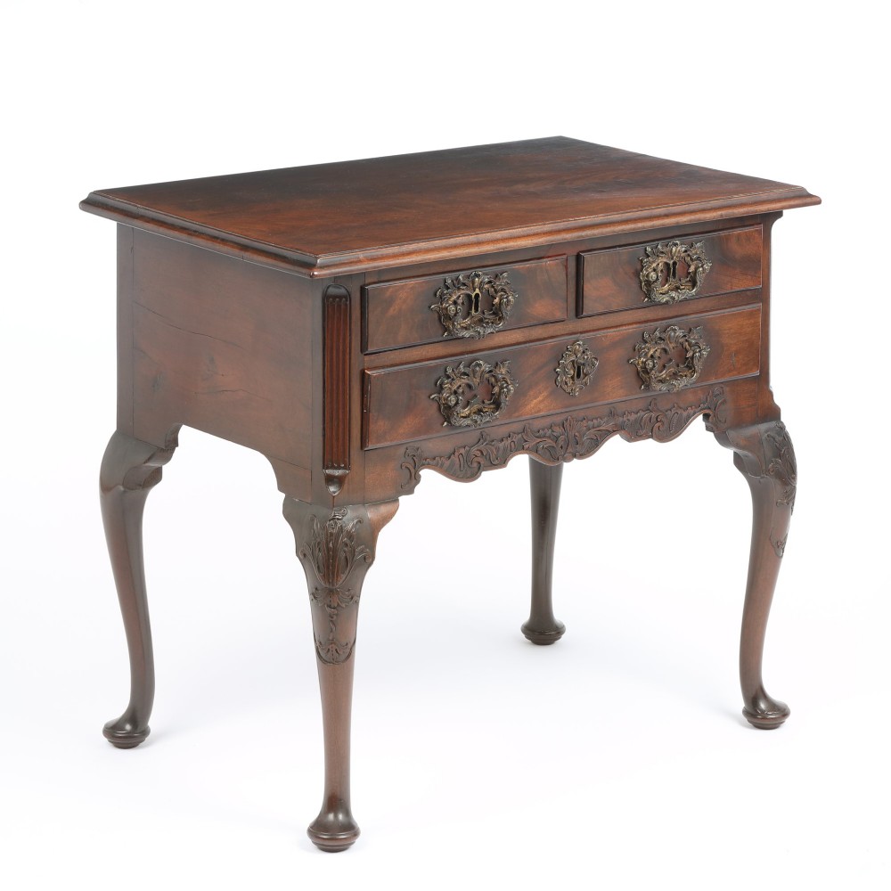 A George II mahogany lowboy side table featuring three drawers, ornate brass backplate handles, carved cabriole legs, and pad feet. View III