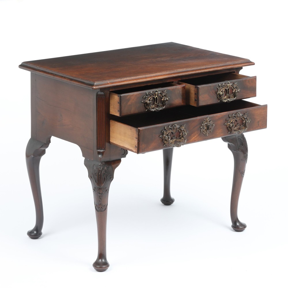 A George II mahogany lowboy side table featuring three drawers, ornate brass backplate handles, carved cabriole legs, and pad feet. View V