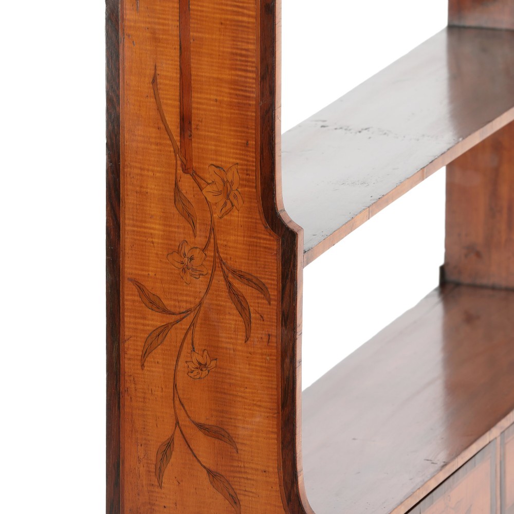 An antique satinwood and mahogany wall-hanging waterfall shelf featuring three open shelves, botanical marquetry inlays, and two small drawers at the base. View III