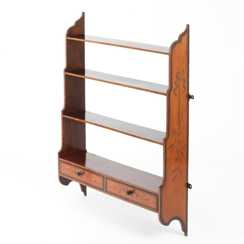 An antique satinwood and mahogany wall-hanging waterfall shelf featuring three open shelves, botanical marquetry inlays, and two small drawers at the base. View IV