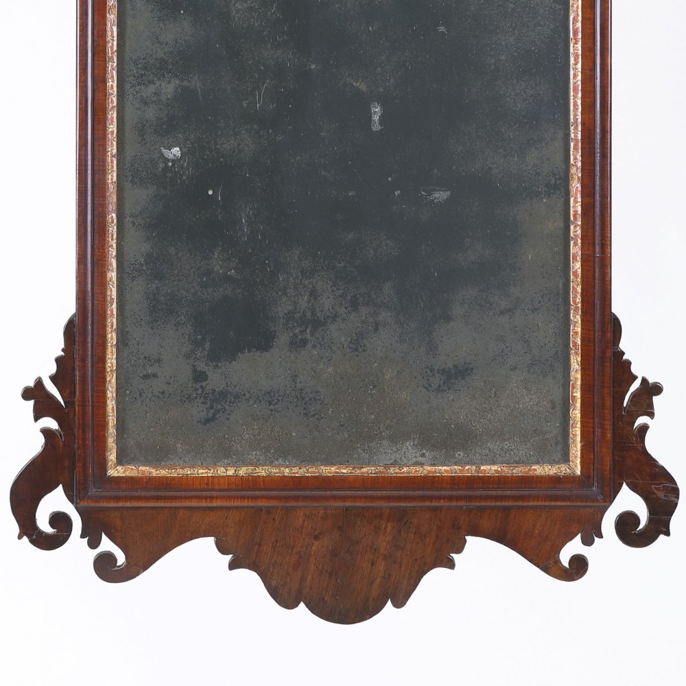 A rectangular Georgian mahogany wall mirror featuring a scroll-cut fretwork frame topped with a gilded ho-ho bird cresting. View III