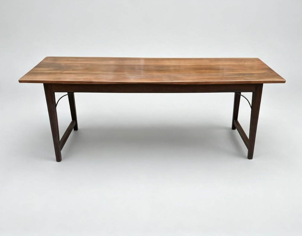 An antique rectangular refectory table made of warm fruitwood timber featuring a multi-plank top, dark legs, and metal corner support braces. View II