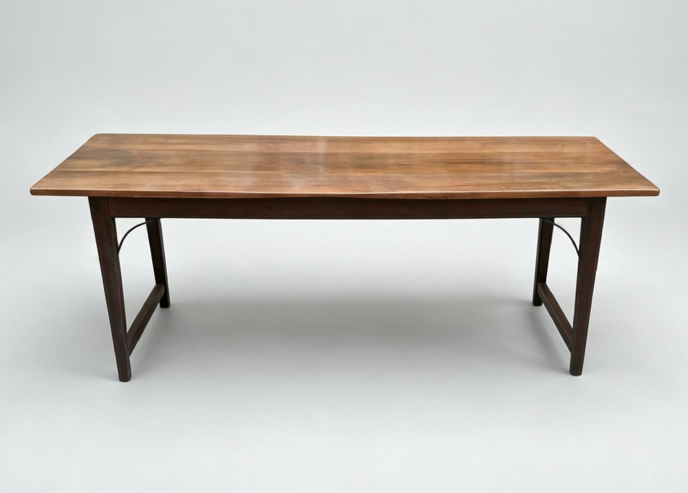 An antique rectangular refectory table made of warm fruitwood timber featuring a multi-plank top, dark legs, and metal corner support braces. View VI