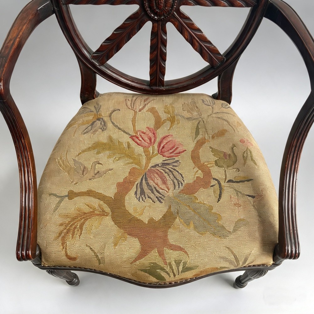 A set of ten mahogany wheelback dining chairs with carved circular backs and floral tapestry upholstered seats. View III