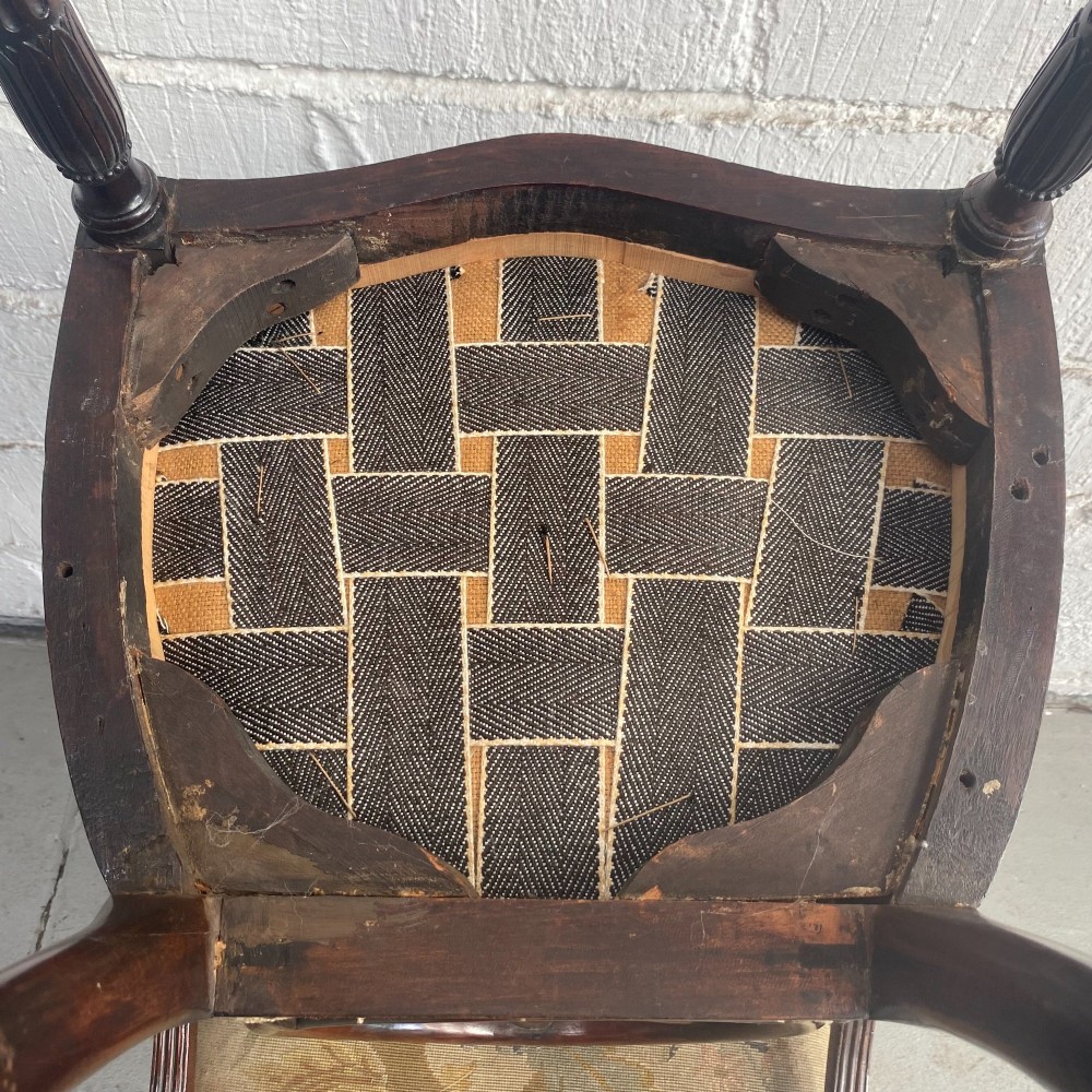 A set of ten mahogany wheelback dining chairs with carved circular backs and floral tapestry upholstered seats. View X
