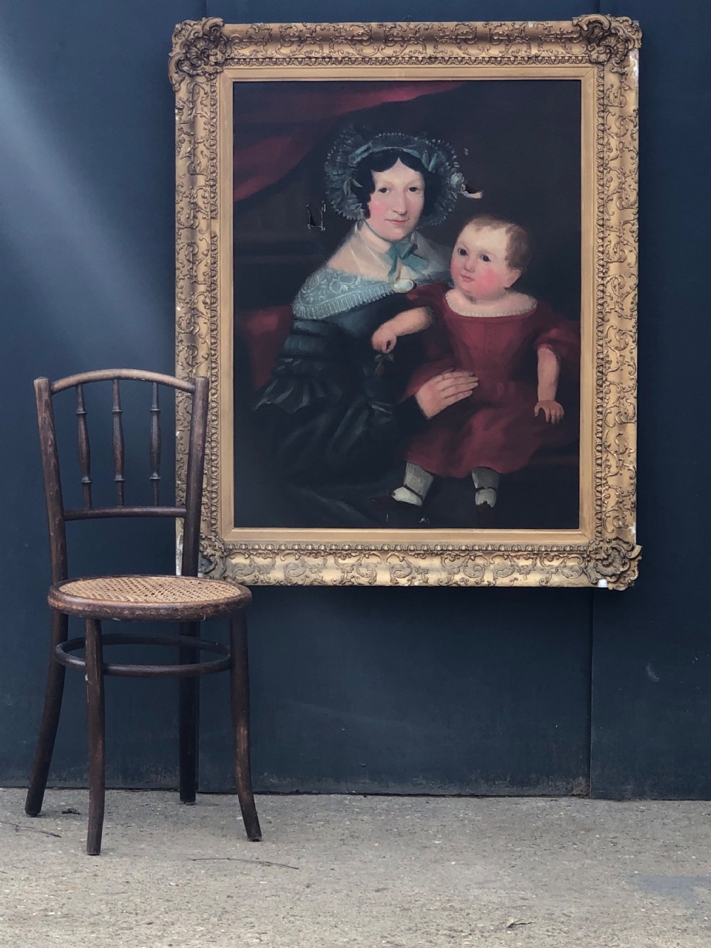 Naive folk art oil on canvas of woman and child (boy) in red dress